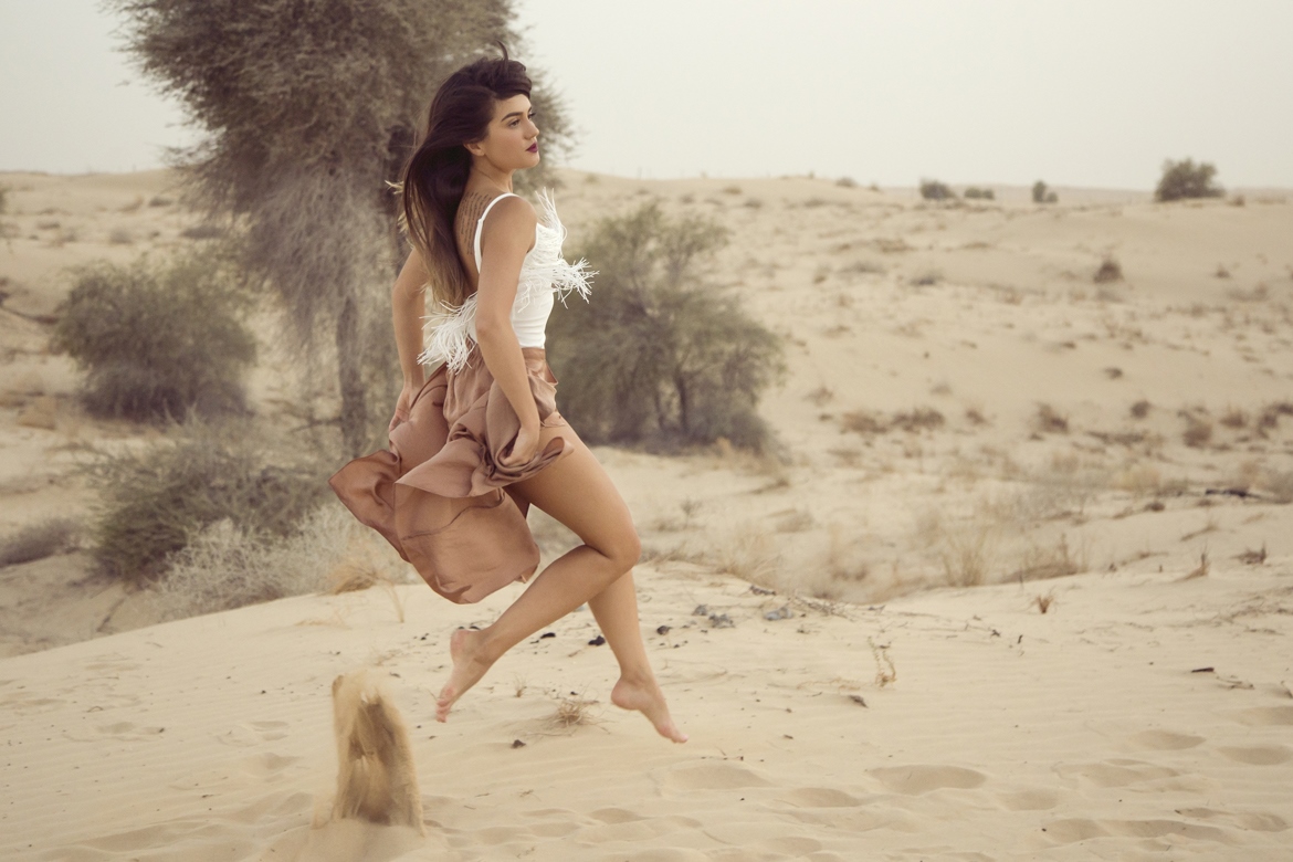 Girl jumping in Desert