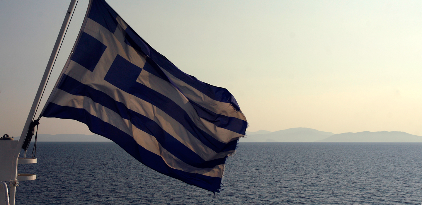 Greece flag with the view on seaside