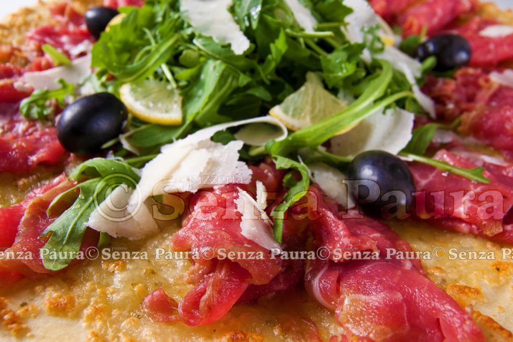 Raw meat tasty pizza with olives